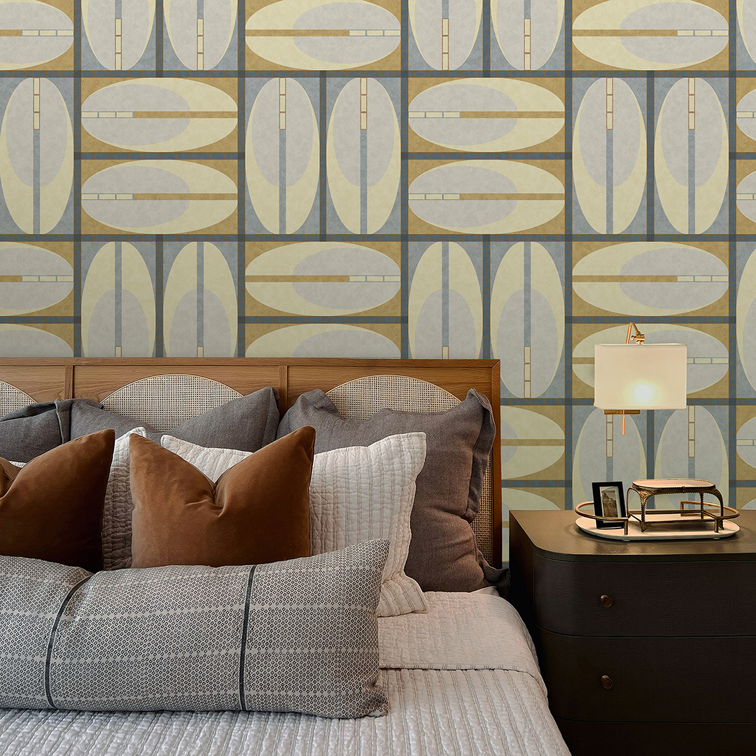 The artwork features a repeating geometric pattern of symmetrical shapes resembling elongated, curved diamonds or petals in various shades of blue and green. Each shape is split vertically with one half filled with a light blue and the other half filled with green or darker blue. The background is a light, almost pastel blue, which provides a soft yet vibrant backdrop. One of the blue shapes near the upper left contains a white starburst element, adding a focal point of brightness to the composition. The overall design conveys a modern, mid-century aesthetic with clean lines and harmonious color contrasts.